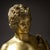 Ormolu bronze figure of Narcissus depicted as a nude youth, mounted on a circular profiled base with anthemion friezes....