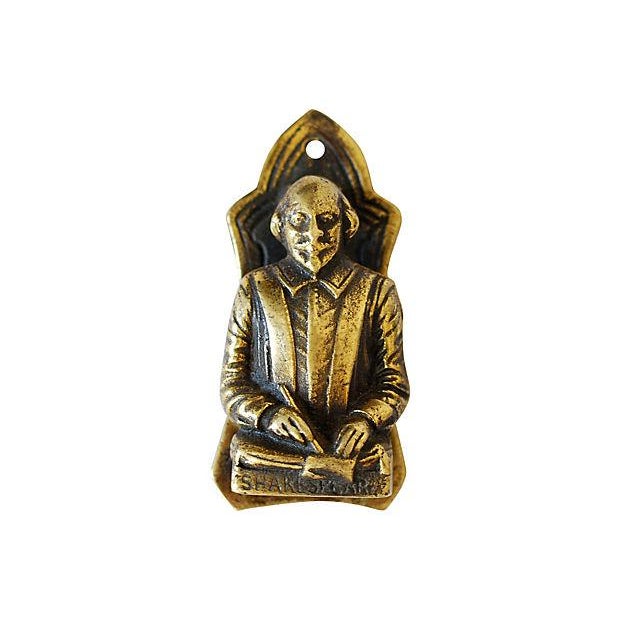 Antique brass door knockers, a pair. One depicting playwright William Shakespeare, and the other Romantic novelist and...