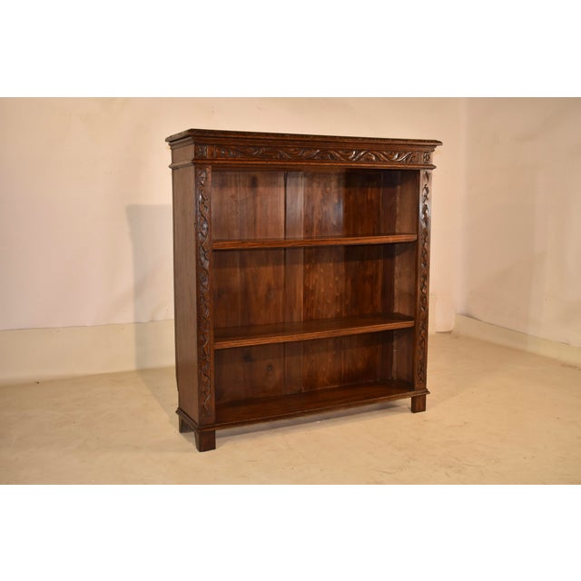 Late 19th century oak hand carved bookcase from France. The top of the bookcase features a lovely and well proportioned...