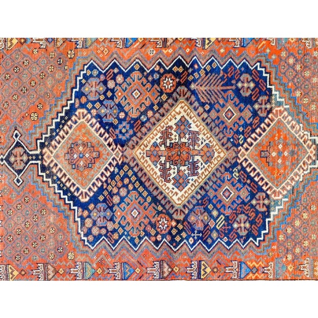 An incredible early 20th Century Persian Ghashghaei rug with three large multicolored diamond medallions amidst a...