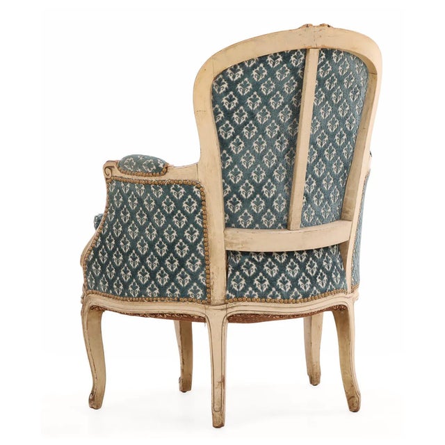 An exceptional decorative pair of French Louis XV-style bergère lounge chairs, dating to 1940s. Distinguished by their...