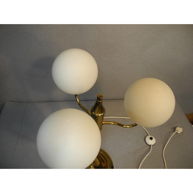 A very unusual and exclusive brass table lamp, an original from the 1960s. A beautiful original 1960s design – not a...