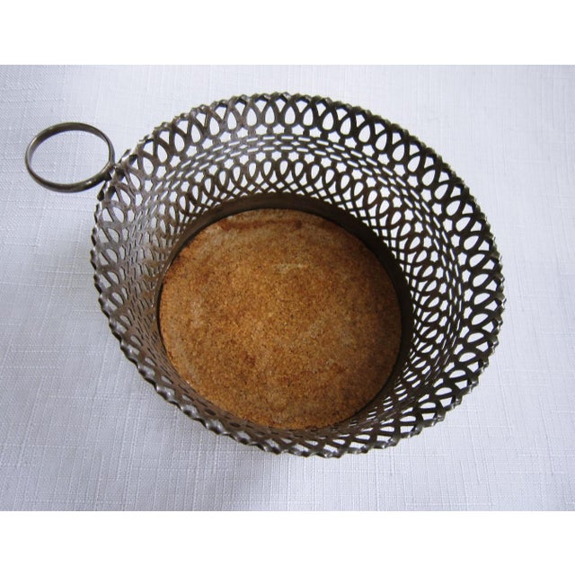 Nicely made wine or bottle coaster by Napier. Round ring handle. Pierced sides and Measures 4" diameter x 2"H.