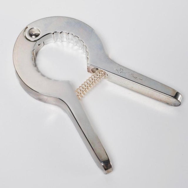 A silver-plated champagne opener by Saint Hilaire, Paris, presented in its original orange box . Saint Hilaire produced...