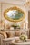 A grand 1980 French Louis XVI-style oval wall mirror, handcrafted from solid beechwood and finished in a warm antique gold...