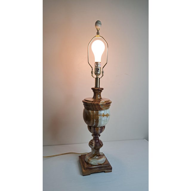 A striking vintage table lamp carved from beautifully banded natural onyx marble, featuring a tall, classically inspired...