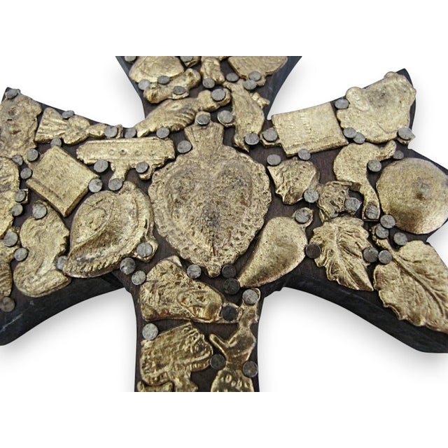 Stunning hand crafted Mexican folk art Milagros cross. Thick hand carved dark wood heavily embellished with gold tone...