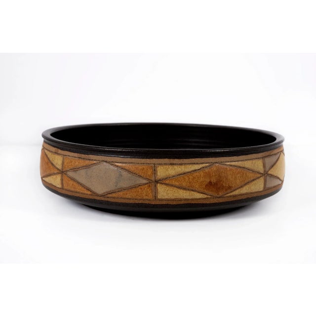 Clyde Burt ceramic decorative bowl in glazed stoneware with incised, abstract details on the outer exterior. Signed to...