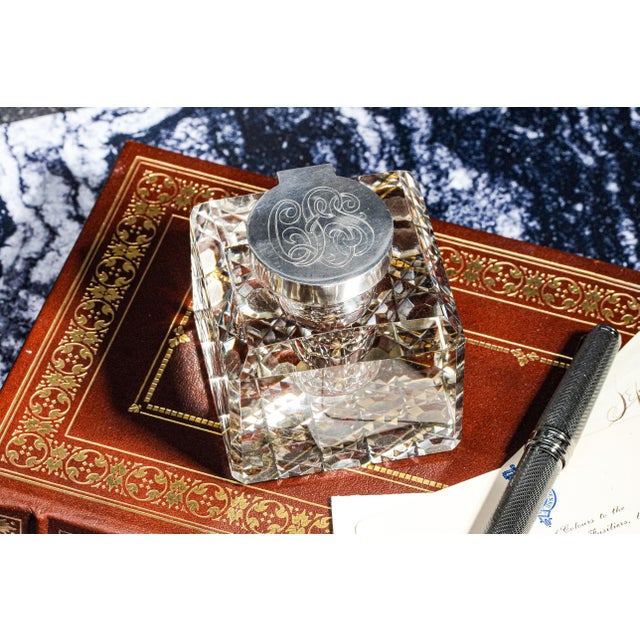 A stunning blend of artistry and function, this large English sterling silver and crystal inkwell is an exquisite piece...