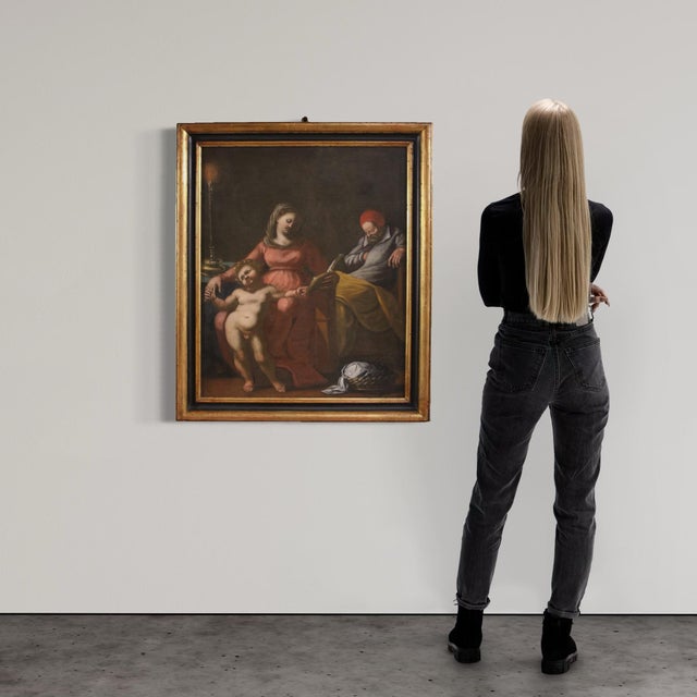 Large 17th-century religious painting. Oil on canvas artwork depicting a splendid Holy Family in a domestic interior. The...