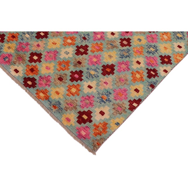 This stunning hand-knotted Afghan Balouchi rug is a captivating addition to any decor. Crafted by skilled artisans, it...