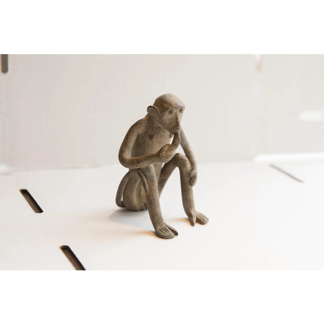 :: Vintage handmade African monkey eating banana figurine. Circa late mid 20th century, though possibly older, this piece...