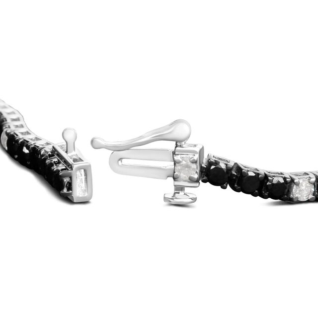 Elevate your style with this striking .925 sterling silver tennis bracelet, featuring a dazzling 4.0 carats of natural...