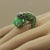 A whimsical and fine quality piece featuring 2.87 carats of round cut tsavorite, 0.35 carats of round brilliant cut...