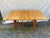 Classic mid-century modern drop leaf dining table, model M166, by Heywood-Wakefield, crafted in solid maple with the...