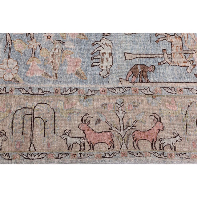 An early 20th century Persian Tabriz rug covered with rows of diamonds filled with medallions enclosed with multiple...