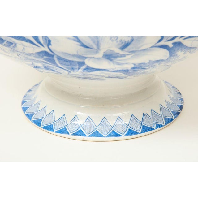 With peony decoration; the sides applied with handles. Bottom inscribed Camelia Deposé with Creil-Montereau mark.