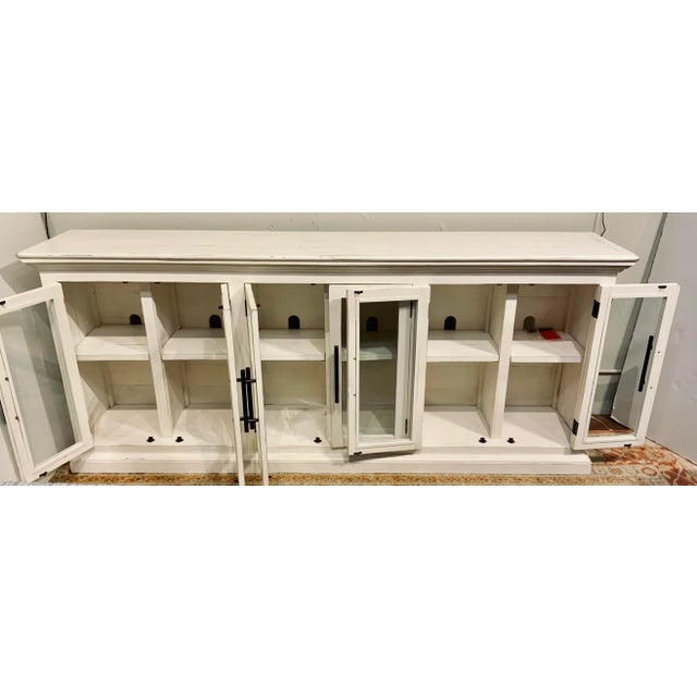 Stylish Organic Aged White Finished Wood and Glass Sideboard, six doors with elongated black metal pulls, six shelves,...