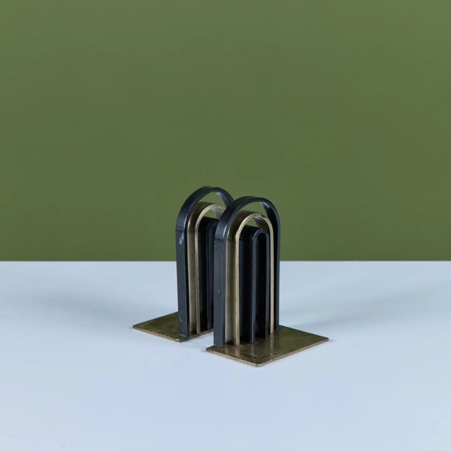 Pair of bronze and brass art deco machine age bookends by Walter von Nessen for Chase, c.1930s, USA. The pair of bookends...