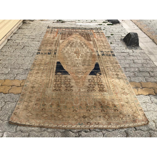 This is a vintage Turkish Oushak rug from the 1960s. The piece was hand-knotted.