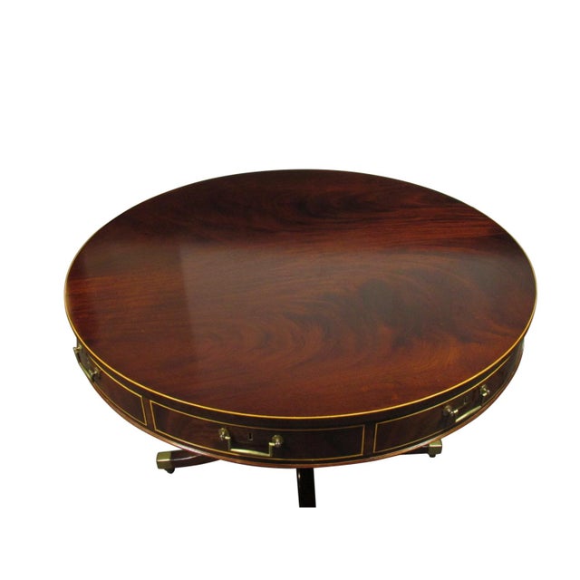 A Regency style inlaid mahogany drum table by English maker William Tillman. Features hand-cut dovetail oak drawer...