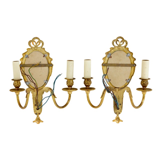 pair of twin arm decorative wall lights circa 1960. oval mirror with bevelled edge, surrounded by beaded edging and swags....