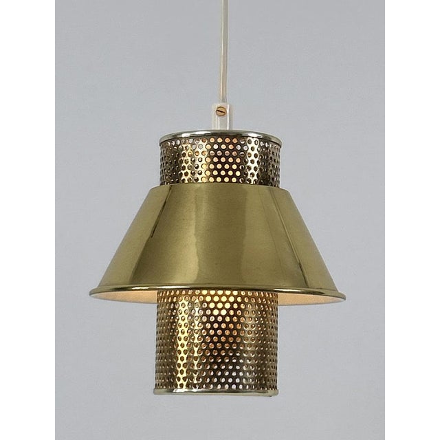 Rare, lovely and highly decorative mid-century modern brass pendant lamp or hanging light. Model t766. Designed by hans-...