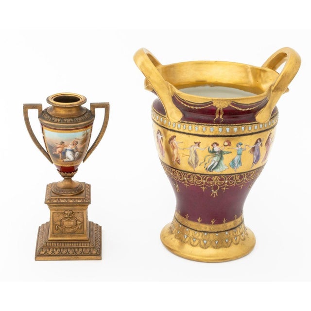 Group of Two Royal Vienna Porcelain Vases, late 19th century, one with gilt metal mounts, painted with a panel of Cupid...