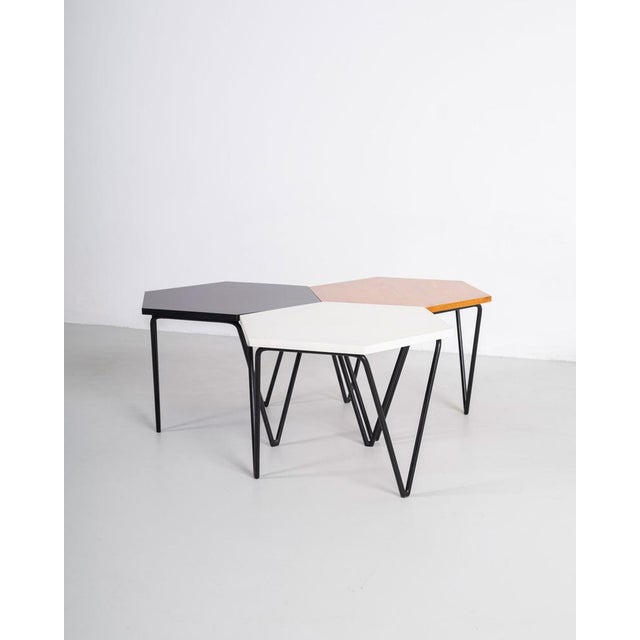 Set of three hexagonal coffee tables with legs in painted metal and wooden/laminate top, designed by Gio Ponti and...