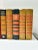 This set of 14 vintage orange decorative books is ideal for color-blocked shelf styling, library staging, and warm layered...