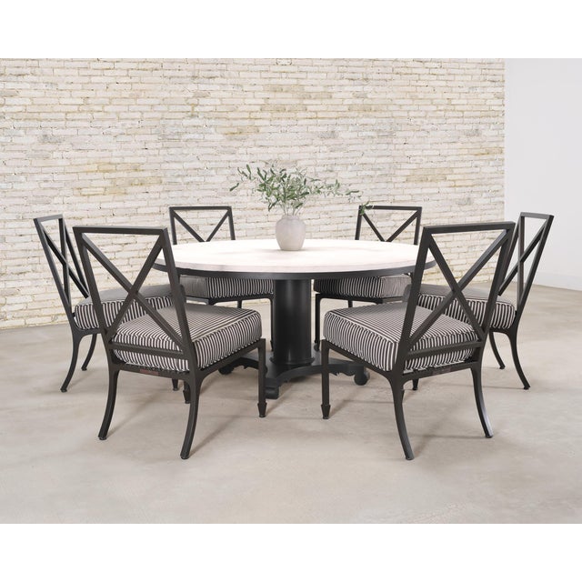 A handsome and elegant seven piece McKinnon and Harris garden suite consisting of an Albemarle round dining table (model...