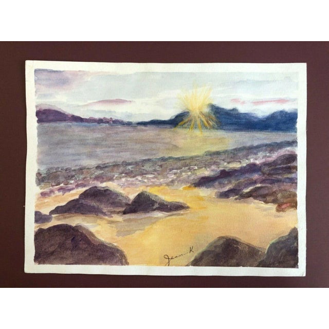 A watercolor of a seascape with a symbolist style sun. 12" x 9" signed by Jean Kesselmeyer, work on paper.