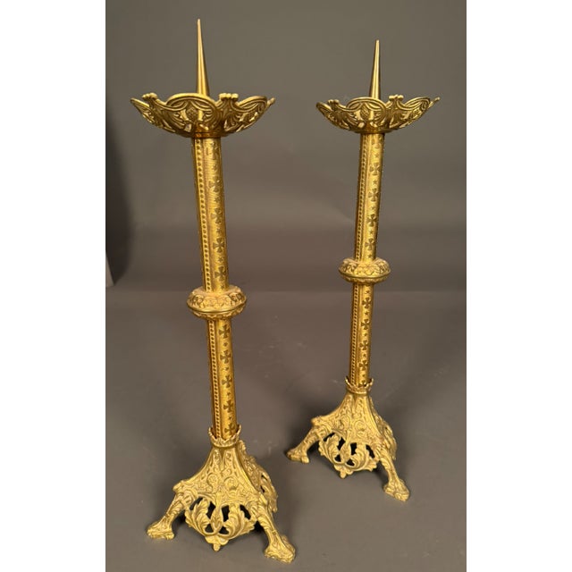 19th century French pair of Gothic style dore bronze candelabras, circa 1850. The candelabras feature decorative castings...