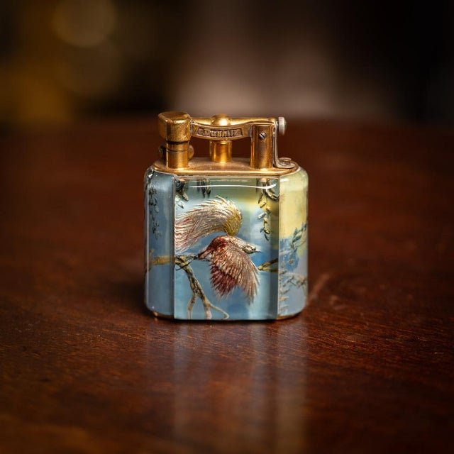 A vintage 20th century dunhill baby "avery" table lighter. Painted with a rich blue ground, this rare avery table lighter...