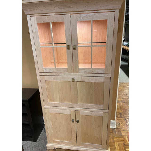 New, Amish-built in 2024, this clear-coated solid hard maple fall-front desk features a lighted display, a glass shelf...