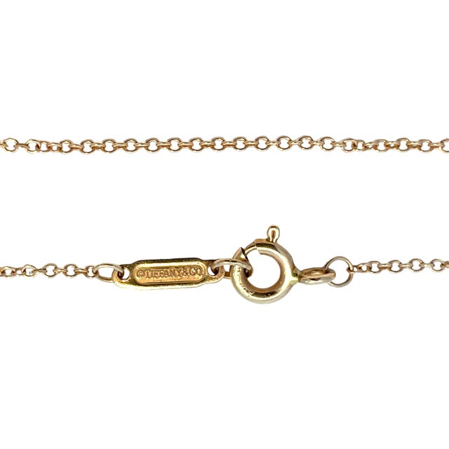 Authentic Tiffany & Co. chain necklace crafted in solid 18k yellow gold, featuring a delicate, lightweight link design...