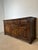 Beautiful large rustic sideboard in solid oak featuring hand-carved panel doors and warm aged patina. The cabinet has a...