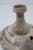 A distinctive pairing of decorative pottery, combining a signed Betty Selby Southwestern figural vessel with a Japanese...