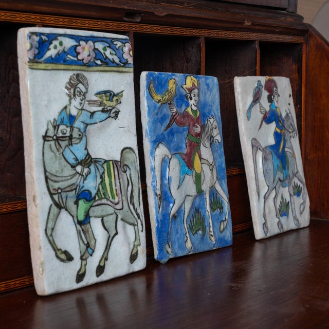 A set of three Iznik Qajar style ceramic tiles. largest: 5 ½ by 9 ½ inches smaller: 8 inches tall