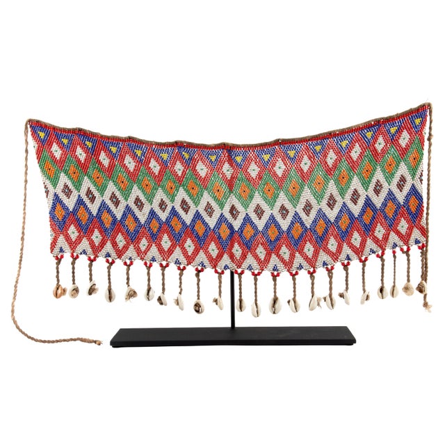 A vibrant, handwoven beaded belt—traditionally known as a cache-sex—crafted from multicolored glass beads arranged in a...