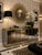 An iconic 1970s Hollywood Regency credenza by Ello, featuring smoked beveled mirror panels framed with polished brass...
