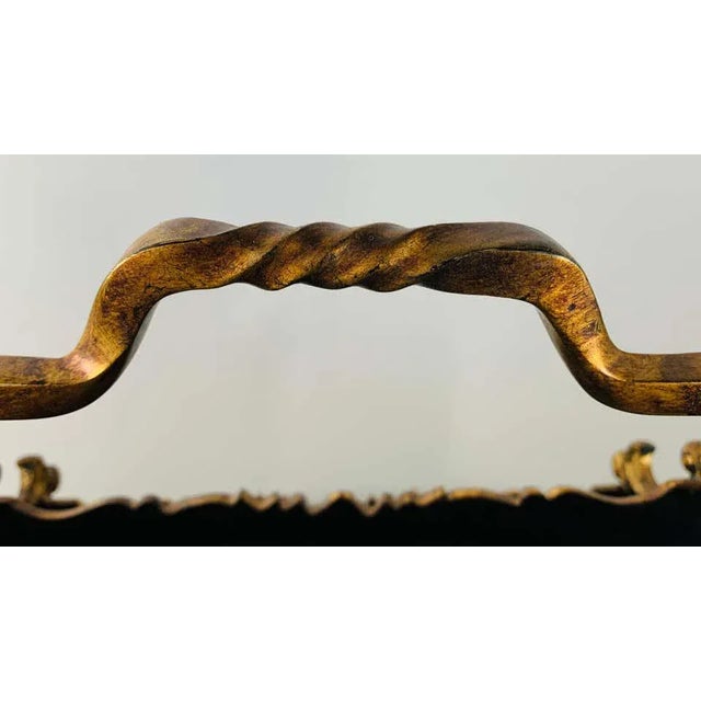 An elegant and beautiful black metal magazine rack with brass frame and handle. The rack is finely decorated with hand...