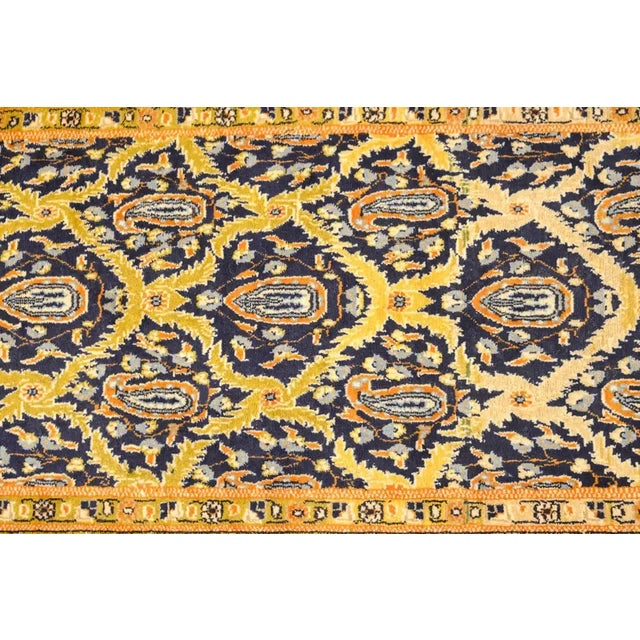 An early 20th century Persian Tabriz runner with a beautiful all-over trellis and paisley pattern woven in cream, gold,...