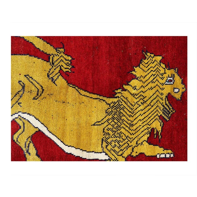 A modern Persian Shiraz small throw rug handmade during the 21st century with a pictorial design of a male lion in yellow...
