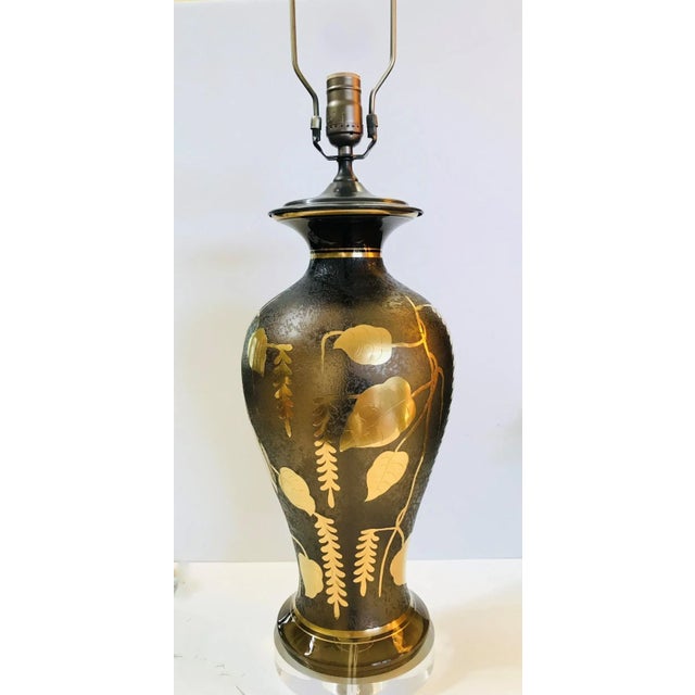 The vintage tall glass lamp has an interesting textured surface which is decorated with an applique of gold leaves, vines...