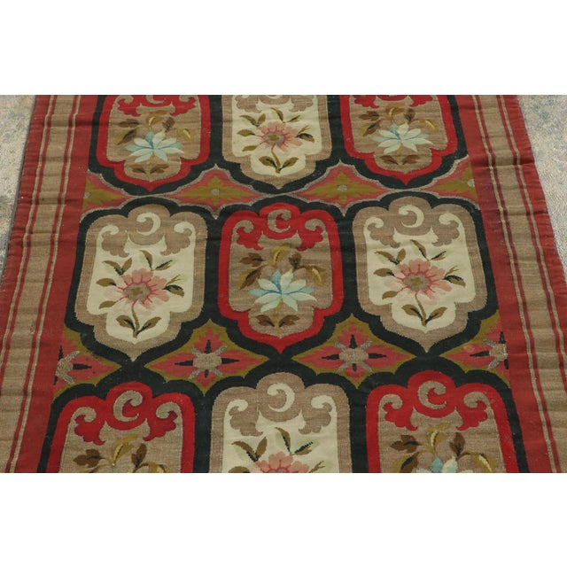 Handwoven in rare metallic threads circa 1890–1900, this striking antique Aubusson flatweave runner from France is an...