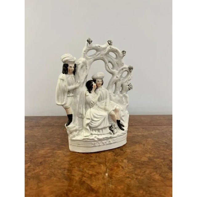 Antique Victorian Staffordshire group having a antique Victorian Staffordshire group of three people, two seated and one...