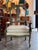 Italian armchair with a shaped open back and curved arms, retaining an early painted surface with visible wear. The back...