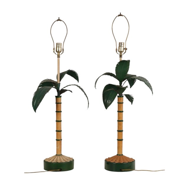 A striking and exceptionally chic pair of vintage mid-century table lamps executed in the iconic Hollywood Regency style,...