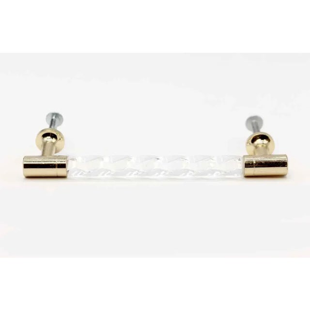 Newly made clear lucite and polished brass drawer pull. Priced each. The manufacturer and exact date of creation are...